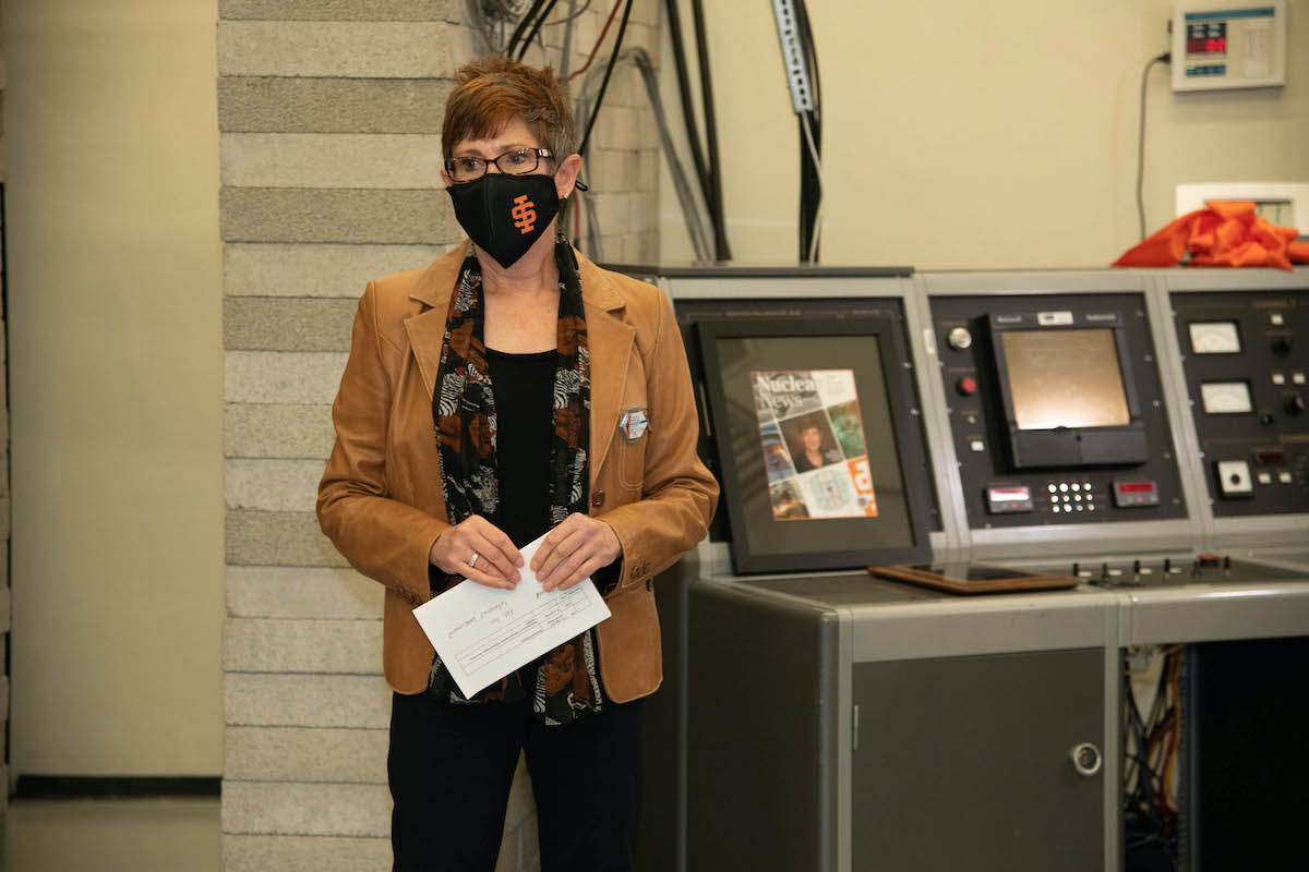 Dr. Dunzik-Gougar wearing mask at nuclear reactor console dedication on Oct. 20. 