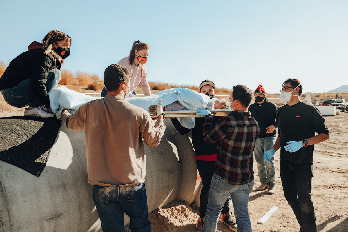 Students lifting stretcher during disaster training.