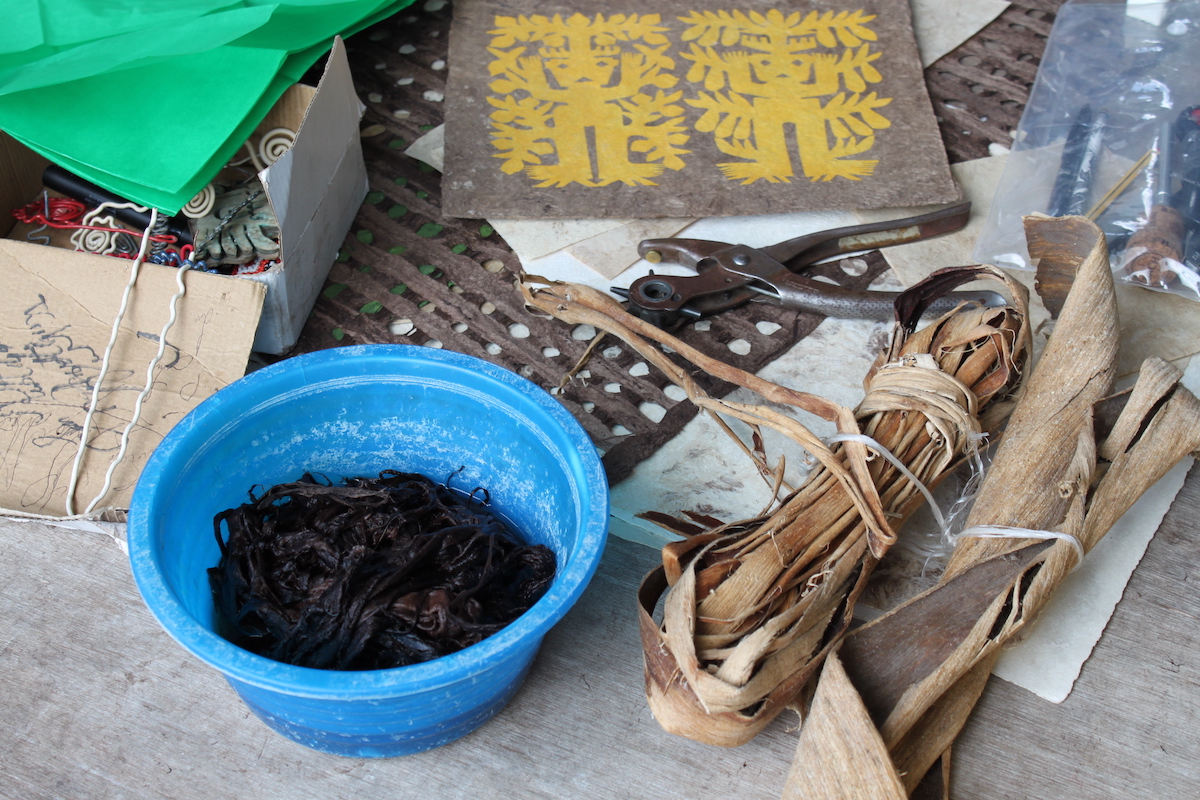 Tools and bark used to make paper in Mexico.