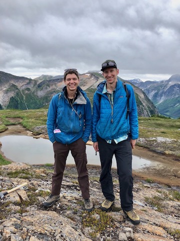 Student and professor, with scenic mountains in background