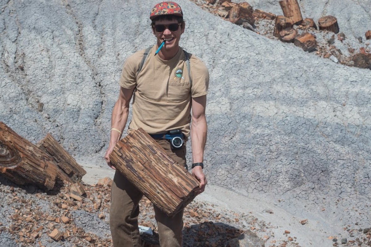 Stuart Parker in the field holding some wood.