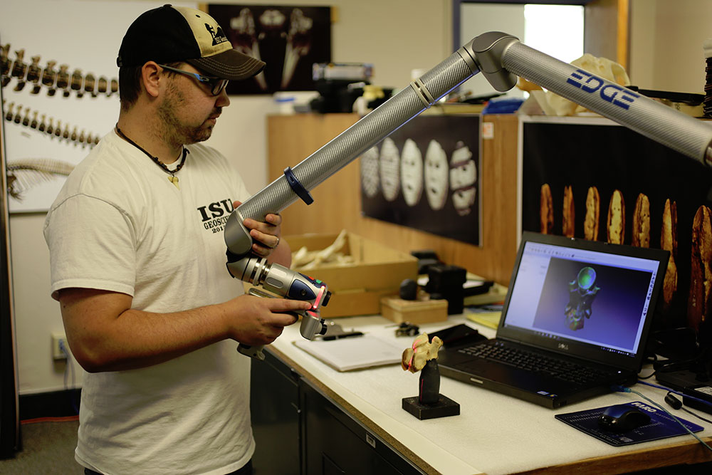 Travis Helm (MS Geology at ISU) scanning a elk's back bone. You can see the digital image on the laptop as the real object is being laser-scanned.