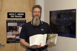 Keith Weber holding copy of NASA publication.