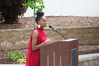 Alma Jam  spearheaded the effort to create a peace pole on campus. Below: The peace pole was unveiled in May.