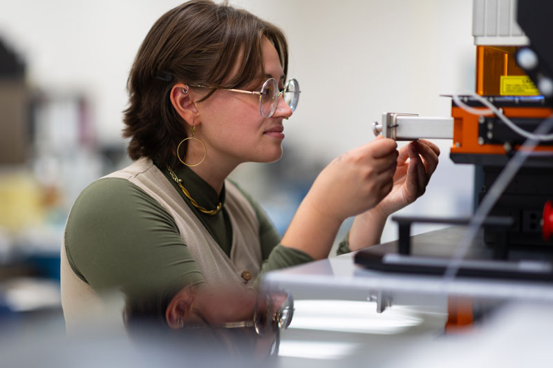 Cheyenne Bartelt, a master's student in geology, loads Zircon samples into ISU's mass spectrometer and laser ablation system