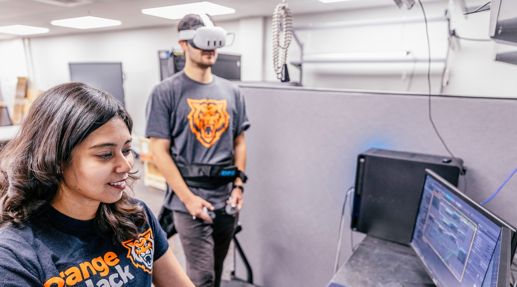 Reece Foulkrod plays Lit-VR, a virtual reality game based in 17th-century London, while Farjana Eishita, assistant professor, observes on-screen.