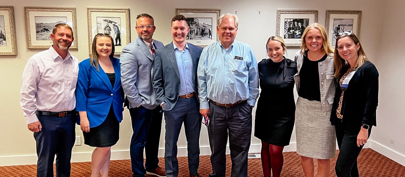 Sandee Gehrke, Raquel Reese Anderson, and Doug Crabtree, pose with other healthcare administration students and faculty.