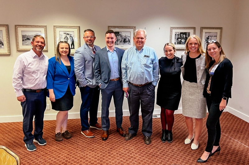 Sandee Gehrke, Raquel Reese Anderson, and Doug Crabtree, pose with other healthcare administration students and faculty.