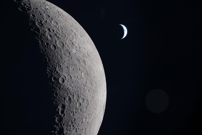 As the Artemis II crew came close to passing behind the Moon and experiencing a planned loss of signal, they captured this image of a crescent Earth. Earth is in a crescent phase, with sunlight coming from the right. Credit: NASA