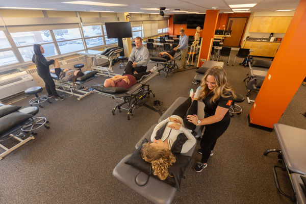 Physical Therapy students practicing leg manipulations and stretches
