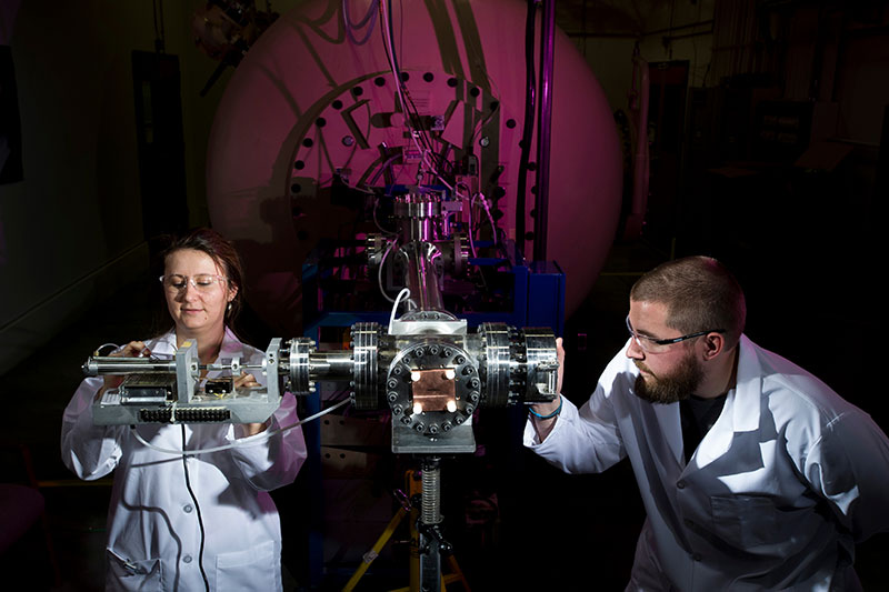 Graduate Students inspecting equipment