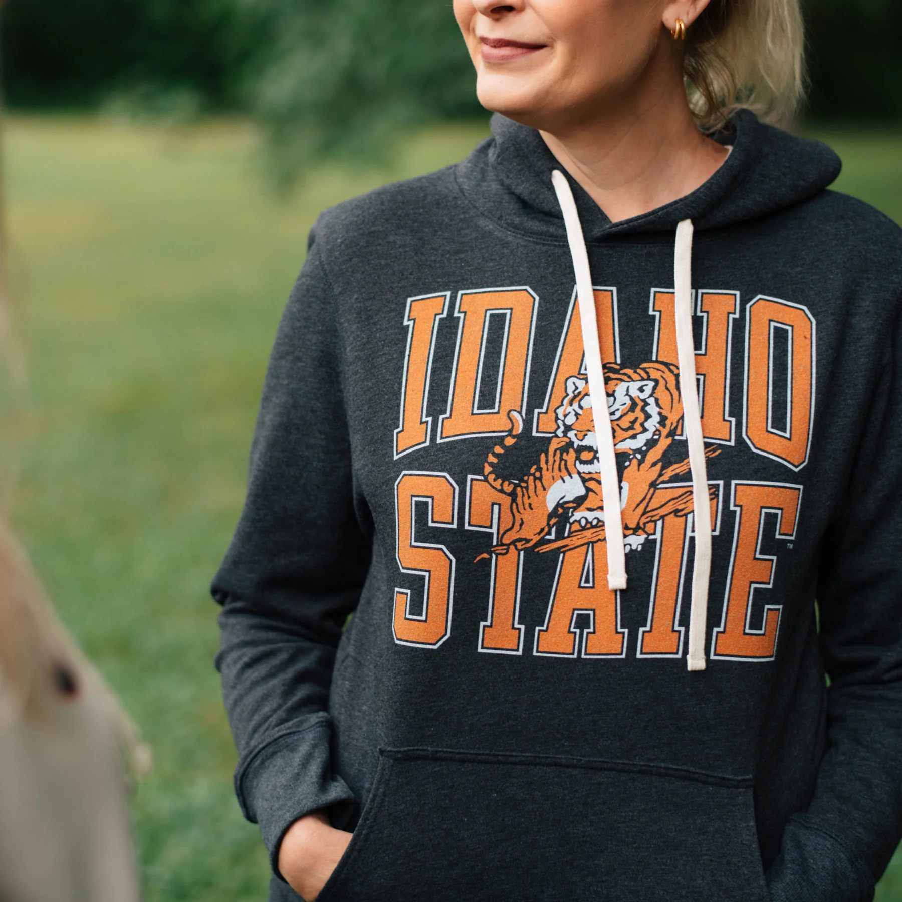 A woman wearing a retro Idaho State University bengal hoodie