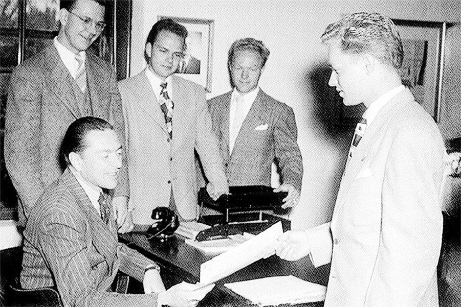 The fight song is presented to President McIntosh by Jay and Del Slaughter, who wrote the lyrics and music respectively.