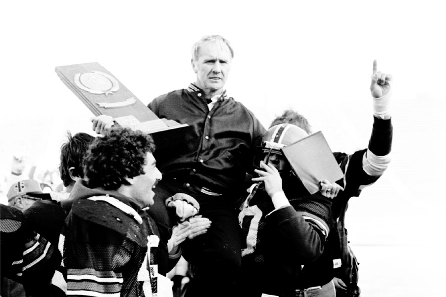 Head coach Dave Kragthorpe, carried by the victorious team.