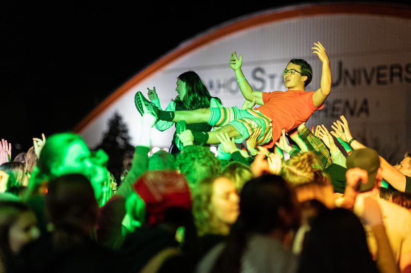 Crowd surfing at the homecoming bonfire