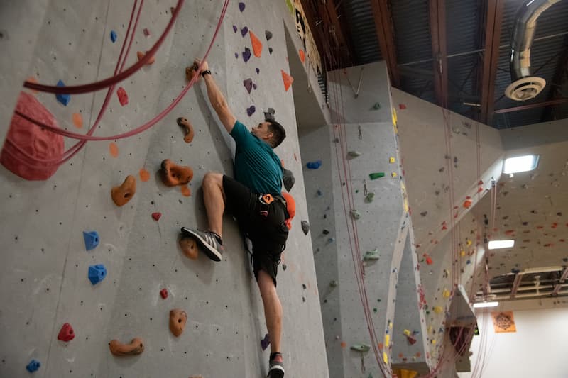 Climber on the Reed Gym rock wall