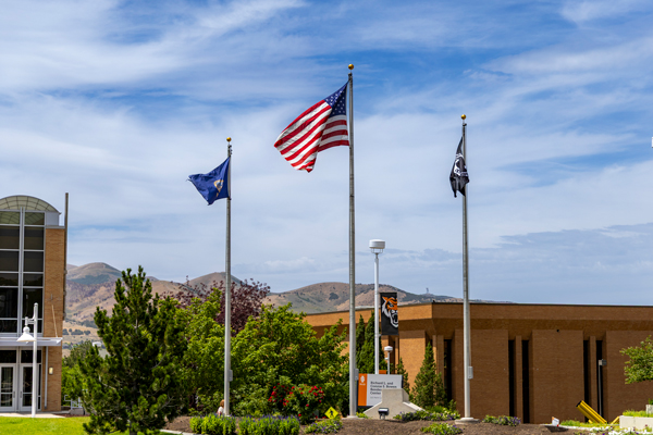 Idaho State University's campus with three flags: the State of Idaho Flag, American Flag, and Prisoner of War Flag