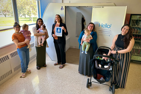 Mothers and babies in front of a new lactation pod at ISU