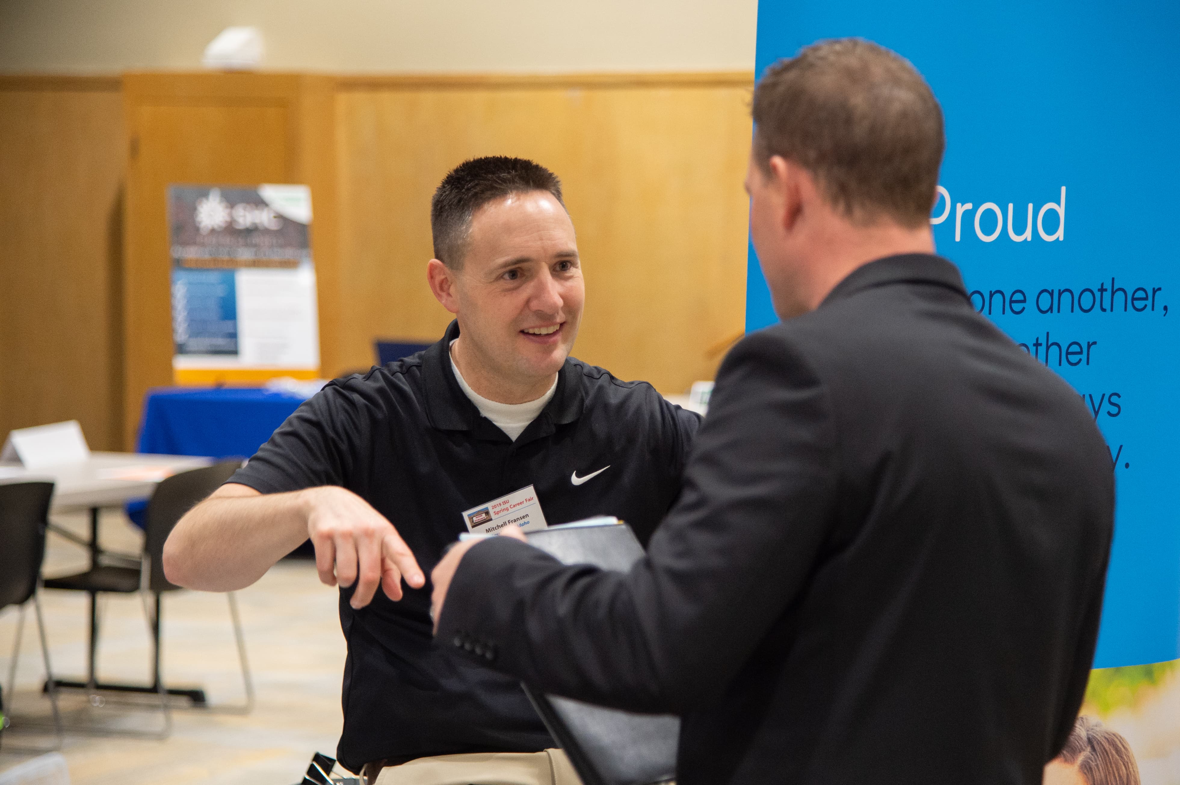 Two men talk at ISU's career fair