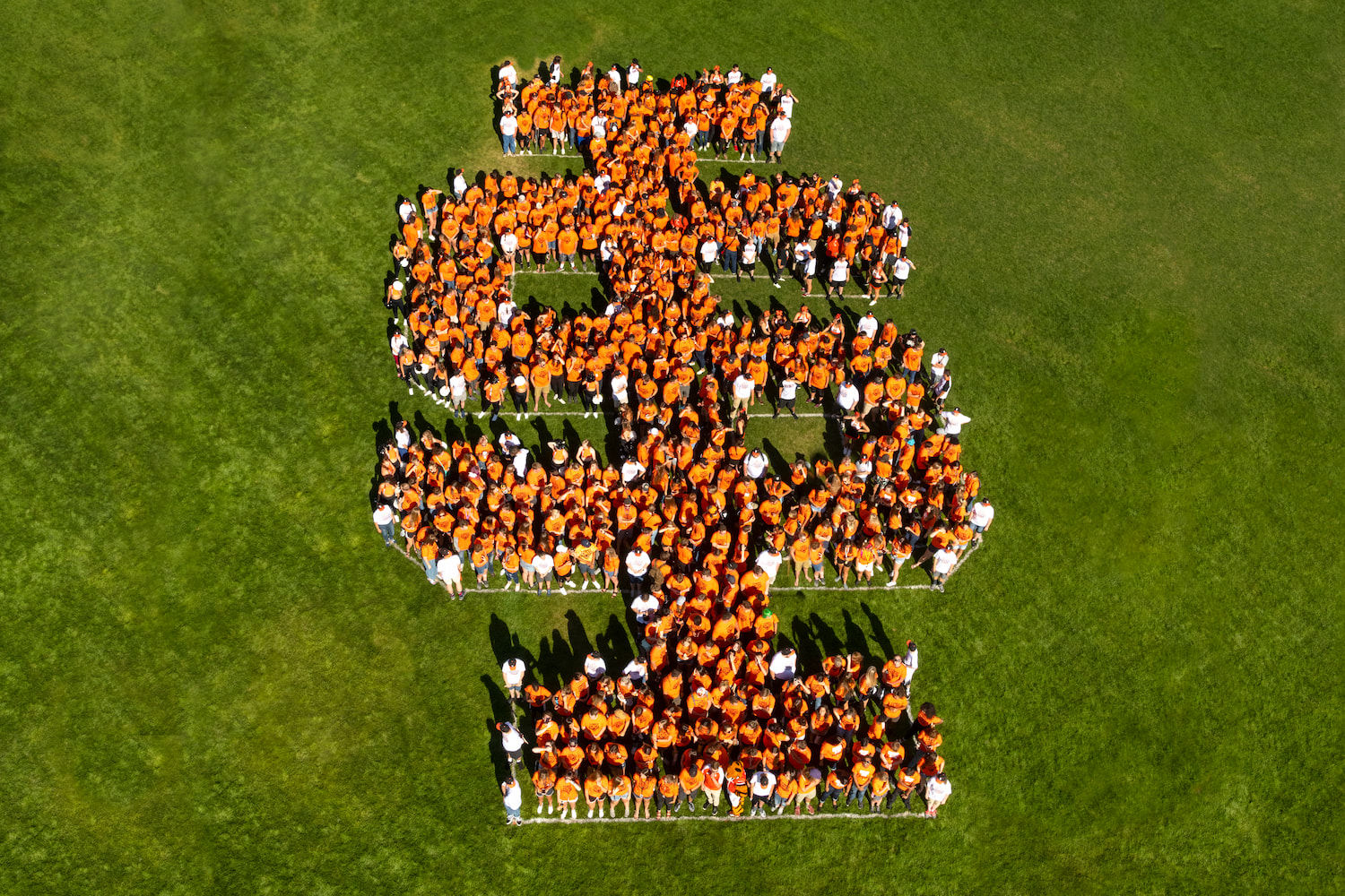 An aerial shot of ISU students grouped together to form the IS logo