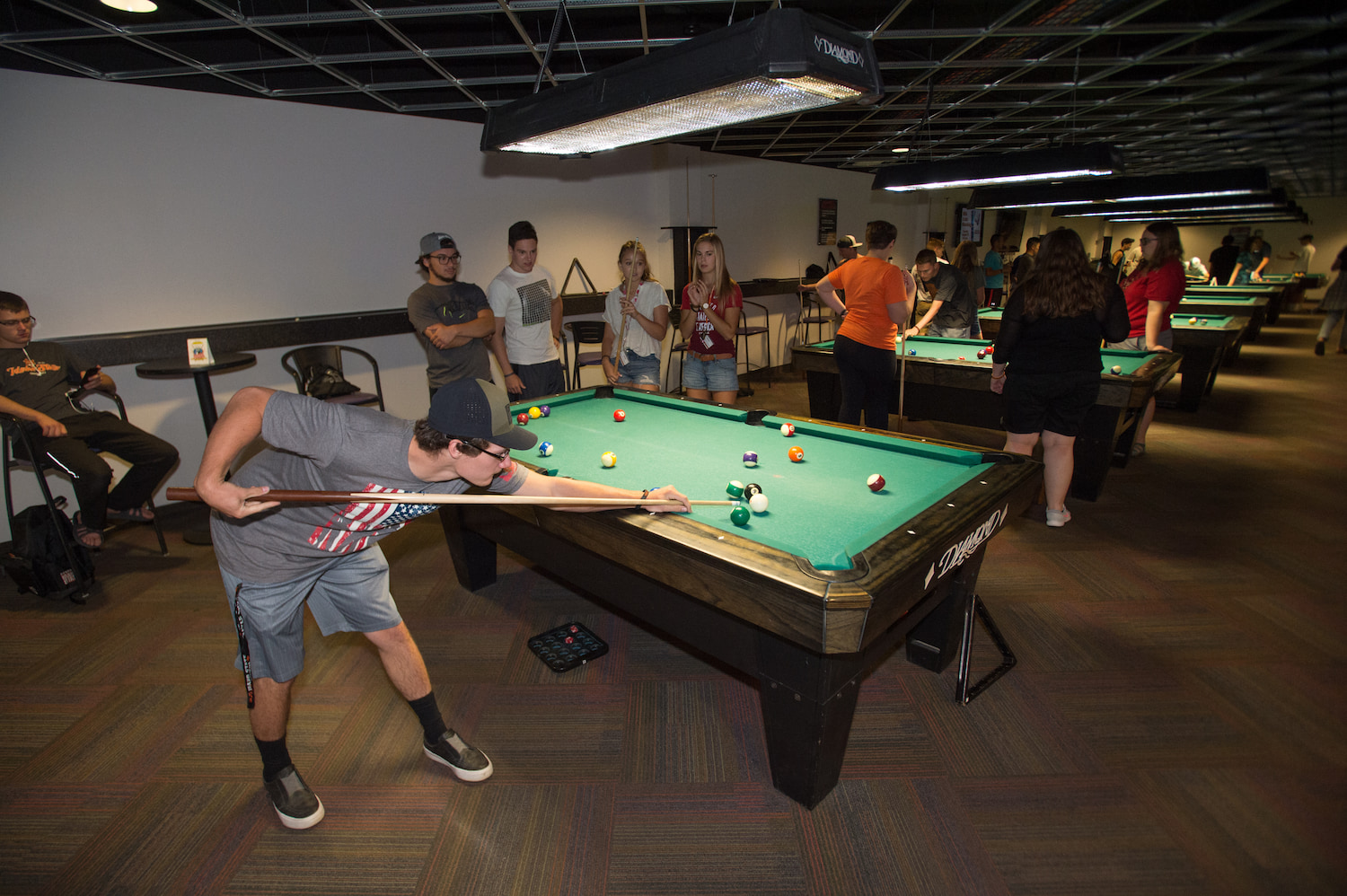 A man prepares to make a billiards shot