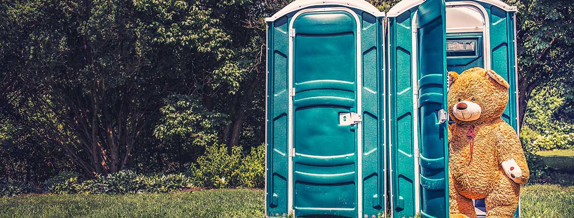 Teddy Bear walking out of portapotty