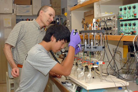 Dr. Rodnick, background, supervises Ben Devaud