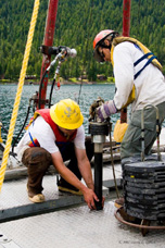 Scientists using the equipment on the deck of one of the drilling boats. Photo by Dave Gilbert.