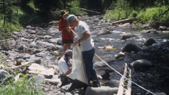 Crew members sampling stream ecosystem conditions in Pebble Creek in 1998. 