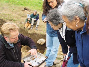 Herbert Maschner in the field in Alaska describing artifacts.