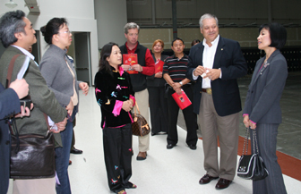 ISU President Arthur Vailas greets members of the Chinese delegation. On his right is  Ping He, a businesswoman who is also serving as an interpreter. 