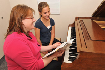 ISU instructor and program assistant Abbi Clark, left, teaches student Allysa Watt. 