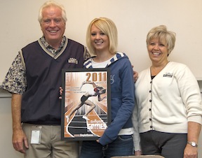 From right,  Rick Phillips, Director of PR at Simplot, ISU student Kari Rands and Rebecca Anderson, Executive Director of Simplot, pose with Rands' winning poster created for the 2011 Simplot Games. (Photo Credit: Tim Frazier, ISU Mass Communication Department) 