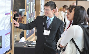 ISU First Year Seminar peer instructor Francisco Ortiz explains his class's community service project during a poster session for the program held at ISU.