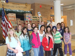 Girl Scout Troop 423 with Casey Santee and the donated cookies.