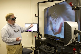 Museum Director Herbert Maschner demonstrates the IQ-Station provided by the INL Center for Advanced Energy Studies.