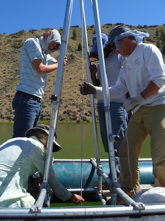 Mark Shapley (right) and field crew (ISU undergrads Andy Salstrom, left, and Chris Kirk, center; Janet Holmgren kneeling) deploy a coring device.