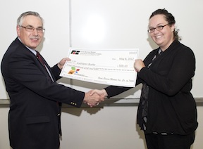 Farm Bureau VP Phil Joslin presents check to Katie Burke, one of six students on the ISU advertising team.