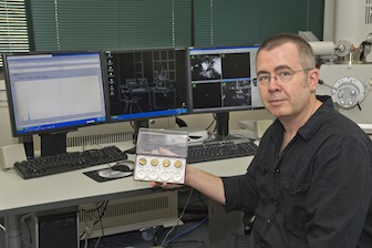 Peterson displays fragments of metal he is studying to learn more about inhabitants of the Russian steppes in the Bronze Age.