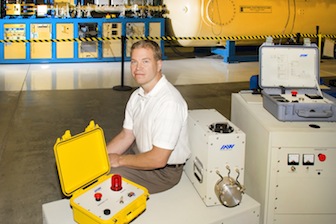 Idaho Accelerator Center engineering physicist Mike Smith is shown with the type of linear accelerator used to check the Mars rover. (ISU Photographic Services)