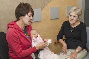 Volunteers Kathleen Olsen, left, and Rosemary Nett get into their roles acting as patients in the ISU School of Nursing's simulation laboratory. (ISU Photographic Services)