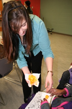 Meagan Horne shares mango chunks with children.