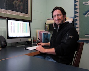 Scot Kelchner in his office, with DNA sequence alignment for bamboos on the computer screen.