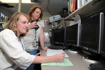 Brandalin Barnes, left, is shown with Evelyn Hoover, who both interned at the INL last summer.  This is a picture of them at a control center at the Materials and Fuel Complex, one of the INL sites.  (Photo used with permission of the INL)