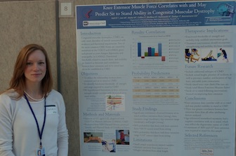 Danson Hall with a poster explaining her research.