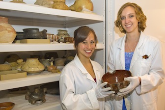 Jennifer Hernandez, left, and Michelle Carpenter, IMNH interns shown here with some artifacts from the IMNH, are heading to Washington, D.C., for Smithsonian internships. 