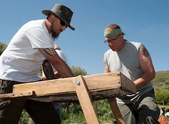 From left, graduate student Adam Clegg and undergraduate Matt Shugert sift for artifacts. (ISU Photographic Services)