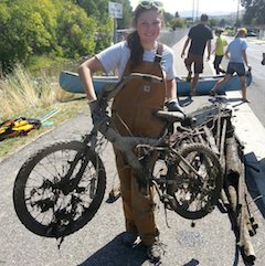 Arwen Baxter, cleanup volunteer and daughter of Colden Baxter, director of the ISU Stream Ecology Center, displays a bike pulled out of the Portneuf River during the cleanup.