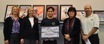 Noi Thannoi (center) holds the winning poster with (L-R) Lisa Woodland, Executive Director Simplot Games; Kristi Samuelson, Assistant Executive Director Simplot Games; Paula Jull, Professor; and James DiSanza, Professor and Chair.  Photo Credit: Matthew Roberts.