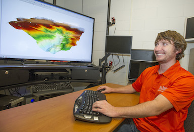 ISU geosciences graduate student W. Joel Johansen works on some WAVE graphics.